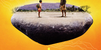 Orange and yellow poster for "Pebbles" movies, showing a boy and man facing each other in a dry landscape